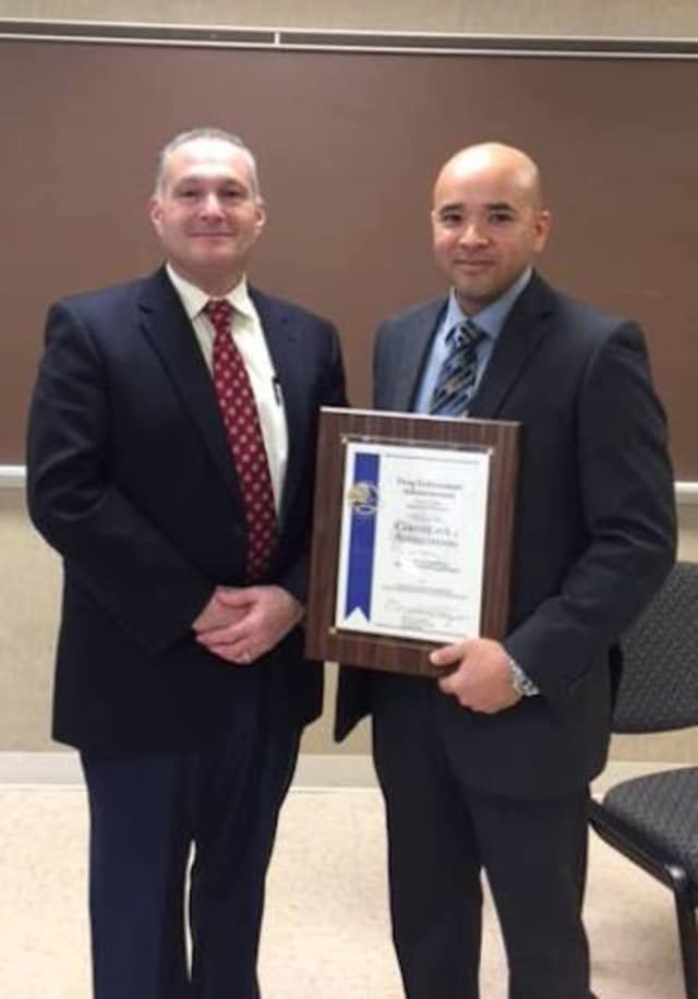 Trumbull Police Detective Edgar Perez is honored Wednesday by the Drug Enforcement Administration for work with the Bridgeport DEA office.