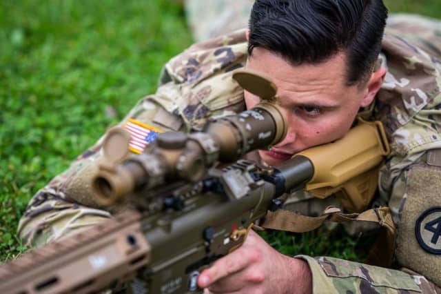 A New Jersey National Guard soldier conducts weapon familiarization with the Squad Designated Marksman Rifle at Joint Base McGuire-Dix-Lakehurst.