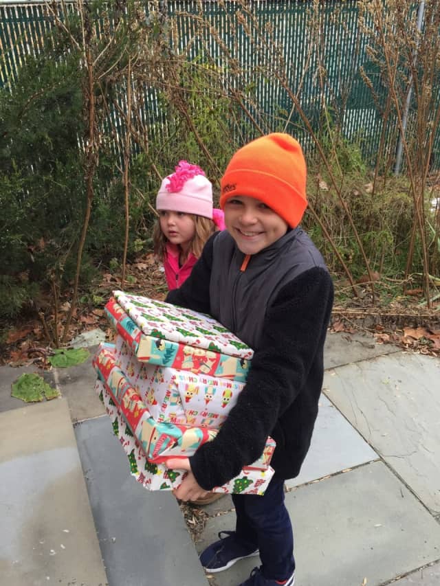 Children with the Families for Astor Committee helped deliver gifts for children of Astor and their families as part of Astor's 2016 Adopt-A-Family program.