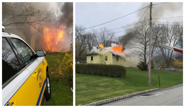 A Washington Township police officer spotted a house fire and helped the residents out moments before it was fully engulfed in flames.