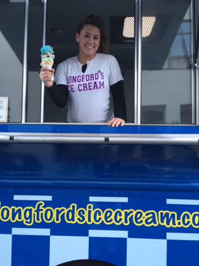 Cali Smith poses in Longford's ice cream truck holding a triple decker cone. 
