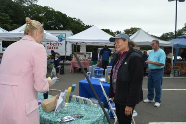Rindy Higgins, right, chair, Westport Shellfish Commission, talks to Westport residents about their shellfishing opportunities in Long Island Sound at the Westport Farmers Market.