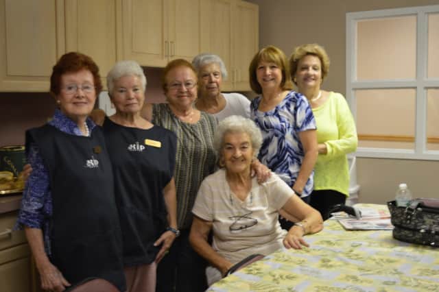 Sadie Guttaso, seated, and Executive Director Peggy Letsche, second from right, with 55 Kip Center members on Sept. 8.