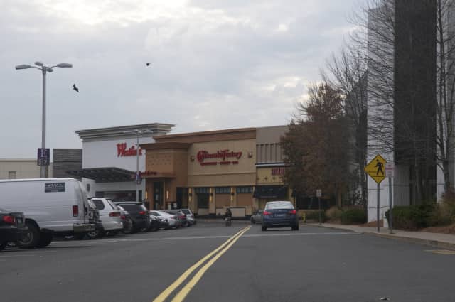 A Bridgeport man was charged with shoving a security officer and fleeing with stolen goods at the Westfield Trumbull Mall