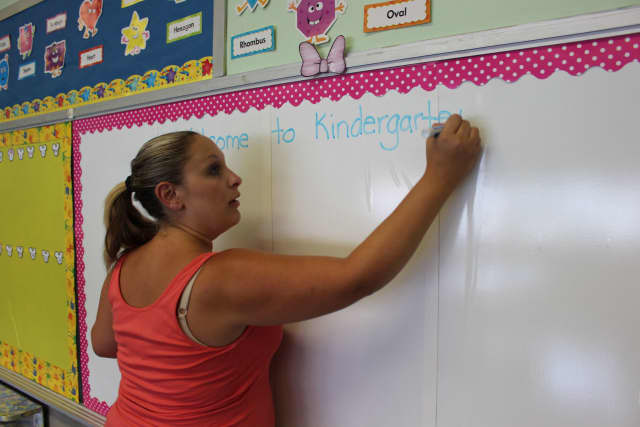 Lyndhurst's Sacred Heart School kindergarten teacher Theresa Roman makes the first introduction on the white board.