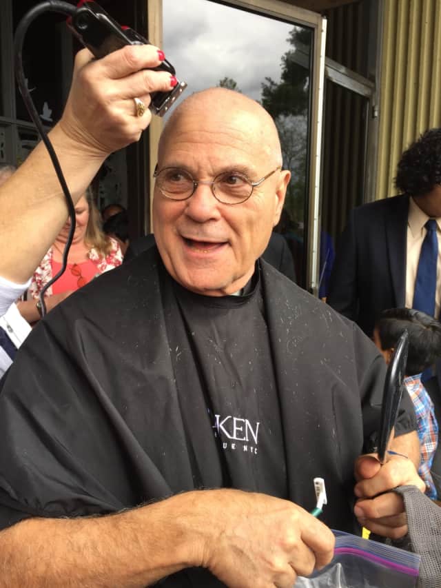 Father Michael Boccaccio, pastor of St. Philip Church in Norwalk, shaved his head and mustache. He did this after the 30 Hour Famine teen group at the church succeeded in his challenge to them to raise $60K to end world hunger.