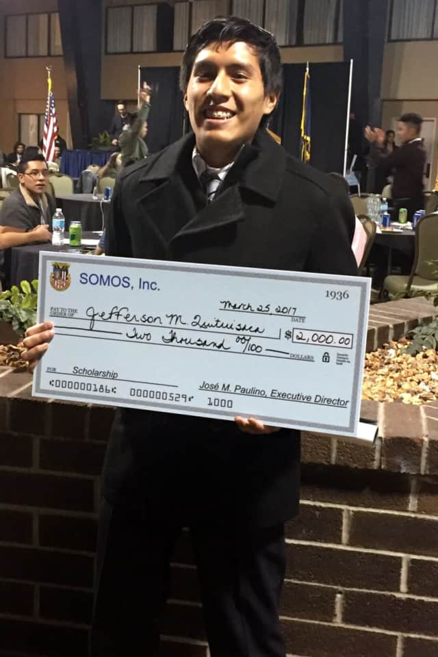 Jefferson Quituisaca with his $2,000 scholarship.