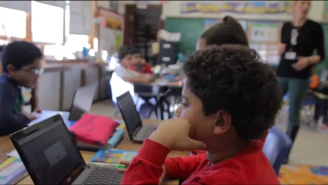 Clifton students work on their computers during a scene in the School No. 11 video for the Follett Challenge.