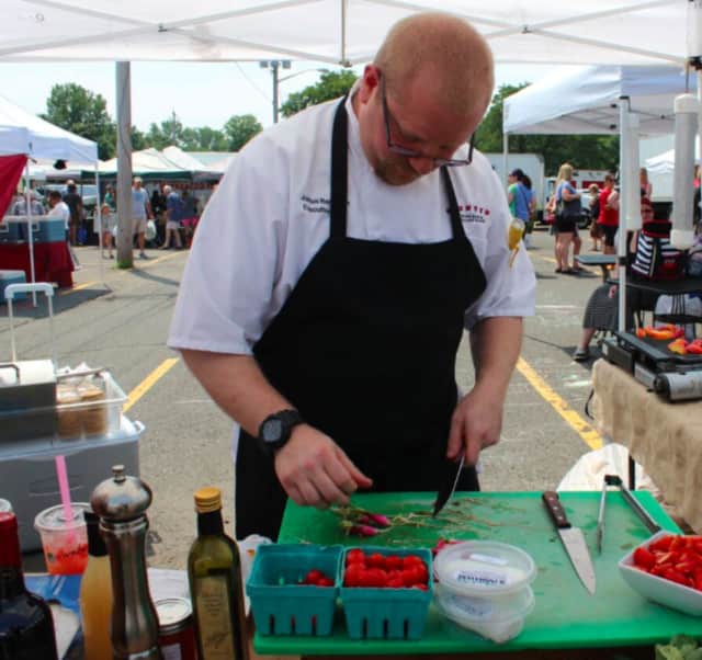 Josh Bernstein uses fresh berries for a cooking demo at the Ramsey Farmers' Market.
