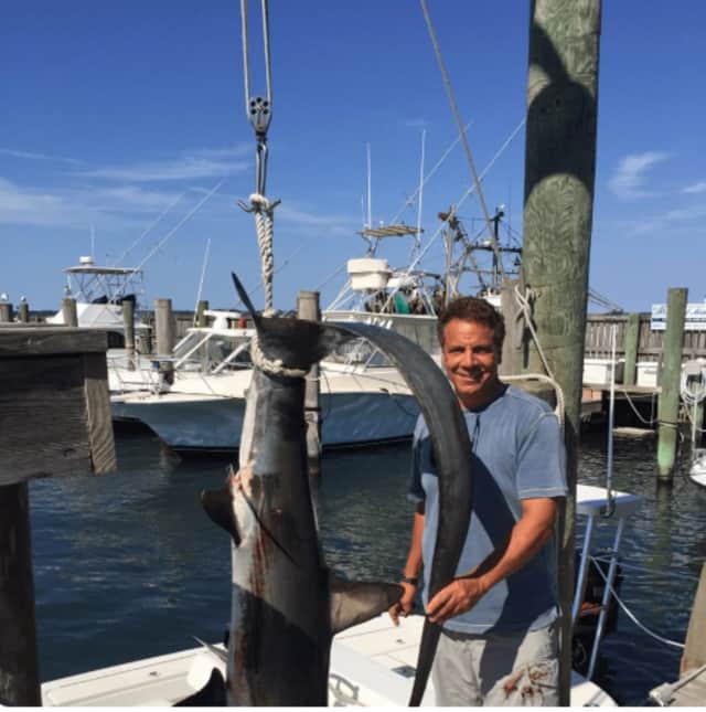 Gov. Andrew Cuomo proudly displays a 154.5 pound thresher shark he caught Sunday on the Long Island Sound.