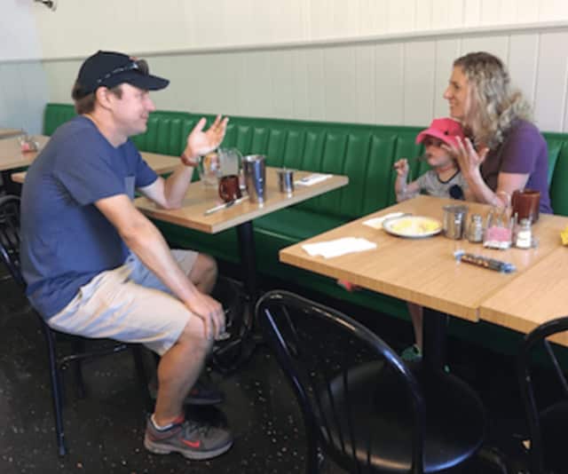 U.S. Sen. Chris Murphy speaks with Fairfield resident Abigail Lorge and her daughter Eliza at the Driftwood Café in Southport on Friday.