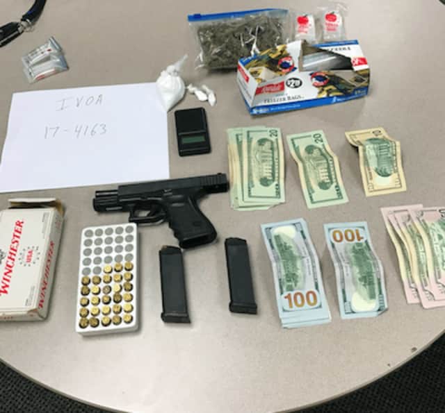 A weapon, drugs and cash that were seized from a Norwalk man during arrest.