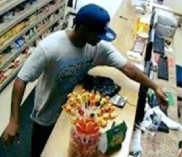 New Rochelle police investigators released a surveillance photo of a man who robbed a local store and threatened an employee.