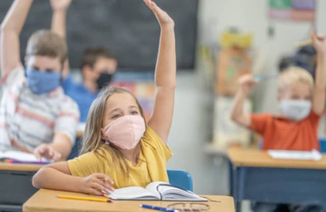 Children in a classroom wearing face masks.