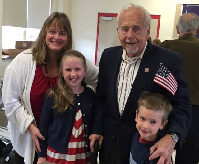 Holmes School students Caroline Carlo and Jack Carlo along with their mother, Joan Carlo, celebrate their special veteran, Robert S. Mitchell (US Navy WWII), at the annual Holmes School Veterans Share.