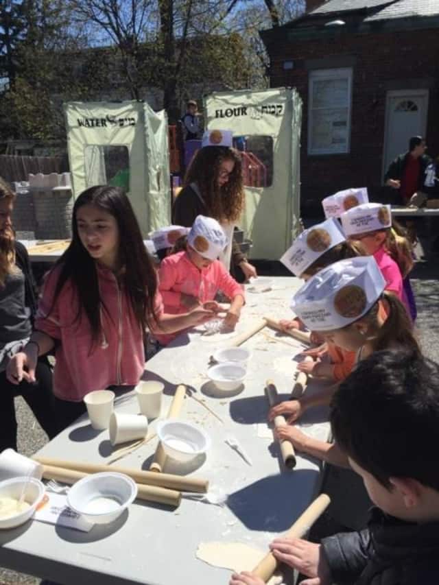 Youth at Chabad of the Rivertowns learned the 15 steps of the seder. Here, they learned to make Matza.