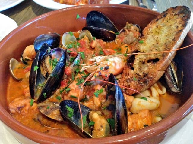 Shrimp, mussels, salted cod and other seafood make a hearty stew for the Feast of the Seven Fishes on Christmas Eve.