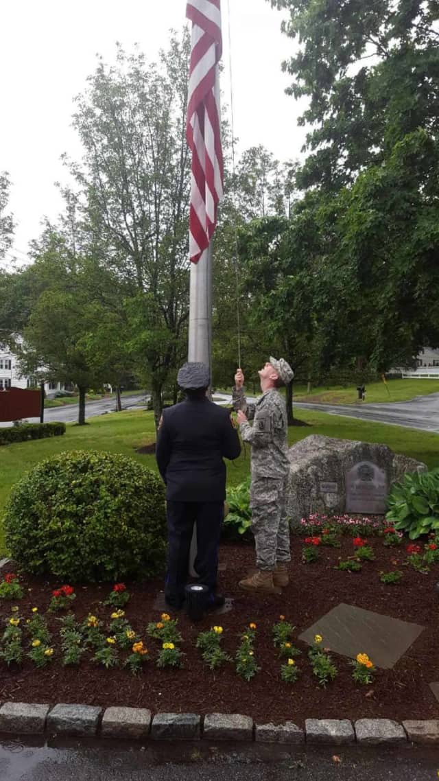 The ceremonial flag lowering at "Monument Rock" on Monday at the Huntington Fire Co. in Shelton.