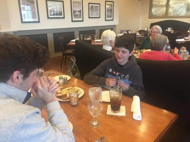 Matthew Hines and his family chat with conversation cards at Riverview Bistro in Stratford.