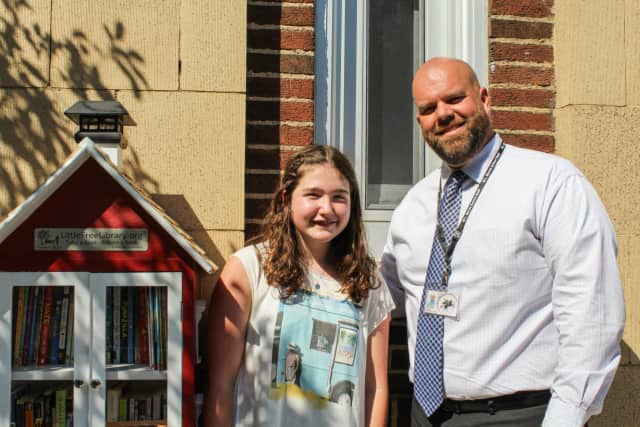 Sleepy Hollow Middle School student Sydney Schulz shows off her little red library she constructed as a bat mitzvah project for the Winfield Morse Elementary School.