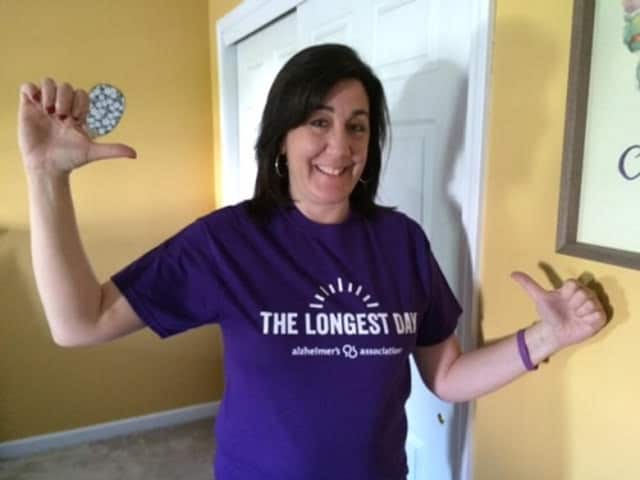 Lauren Voorhees, event coordinator for a fundraising event for the Alzheimer's Association, shows off her The Longest Day T-shirt.