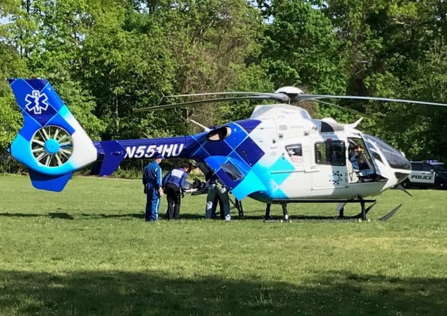The medical chopper picks up the young near-drowning victim at George Washington Elementary School field in Mahwah.