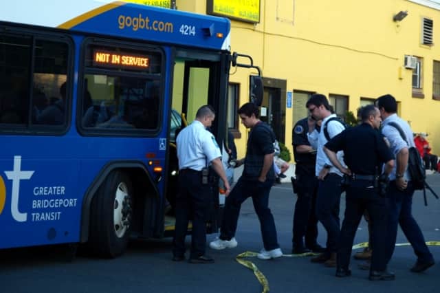 Commuters board shuttle buses after Friday's train crash near the Fairfield-Bridgeport border. Metro-North will continue bus service between Bridgeport and Stamford while the tracks are being repaired. 