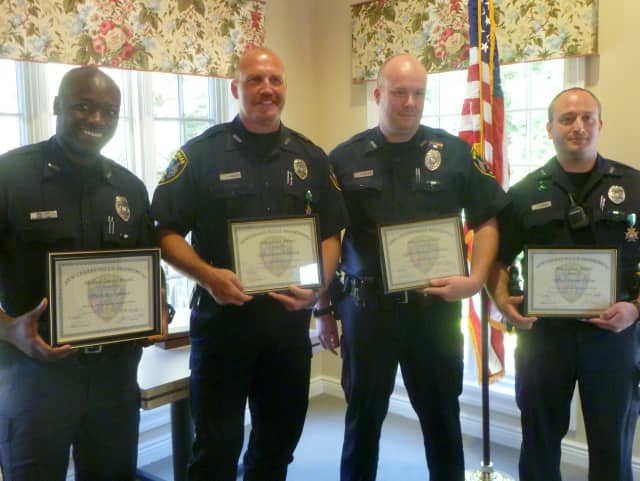 From left: Officers Rex Sprosta, Scott Humberg, Michael O'Sullivan, and Daniel Gulino were honored for their bravery shown in incidents earlier this year. 