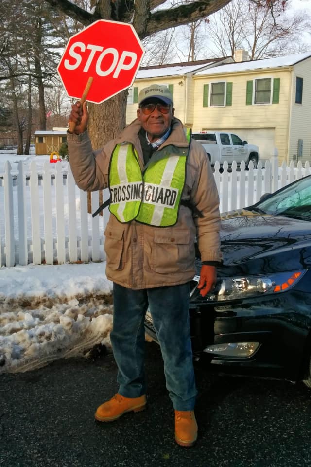Stamford's Roosevelt Mitchell puts a smile on kids' faces in his job as a crossing guard at Pepperidge and Harvest Hill Roads.