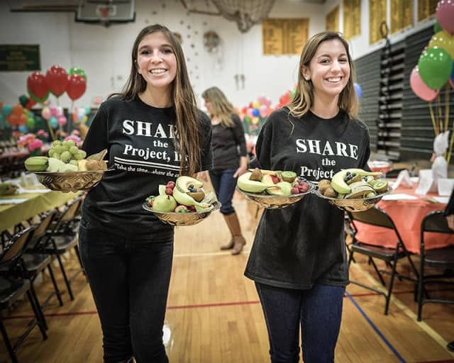 Volunteers distribute meals at Project SHARE's 2013 Thanksgiving Dinner.