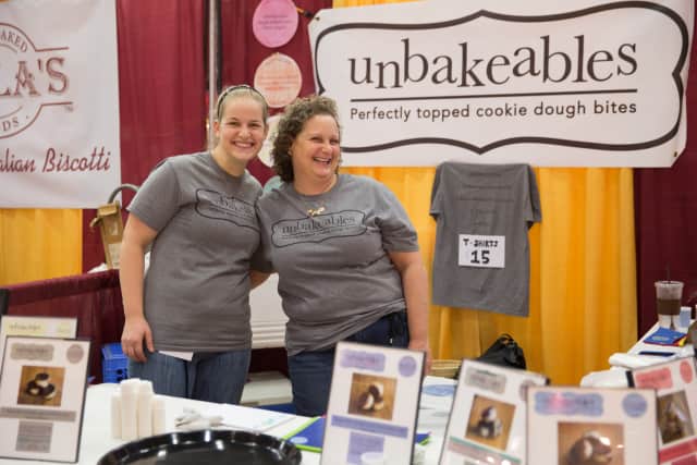 Left to right: Corey and Julie Tolkin show off their Unbakeable cookie dough balls at a trade show.