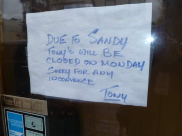 Signs like this one at a Hastings restaurant have cropped up in the windows of local businesses still without power.