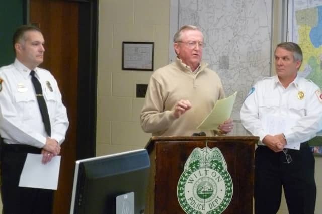 Wilton First Selectman Bill Brennan, center, speaks during a news conference on the town's power recovery efforts on Friday. Flanking him are Police Chief Michael Lombardo, left, and Fire Chief Paul Milositz. 