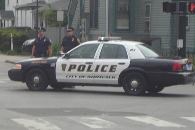 Norwalk police charged a Commerce Street man with interfering with an officer and trespassing Tuesday afternoon.