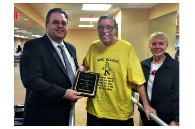 North Salem Supervisor Warren Lucas and Beverly Golisano from Purdys Methodist Church presented the award to John Caralyus in the hospital.