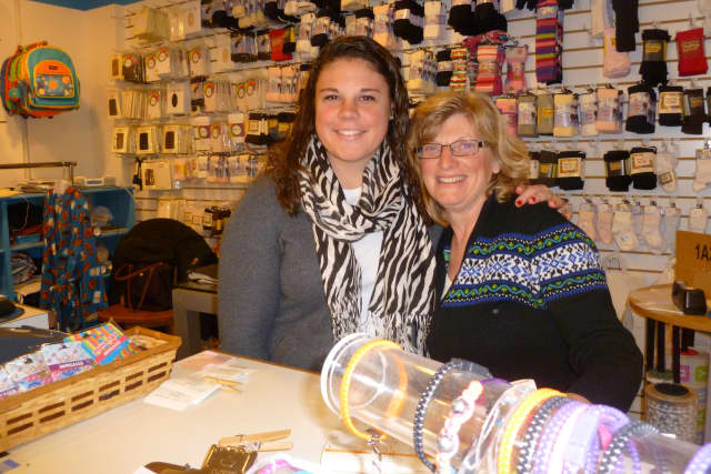 Candy Nichols, a children's clothing store in New Canaan, will move to 99 Main St. in March. Pictured here are co-owner Anna Carberry, right, and sales associate Jennifer Joseph. 