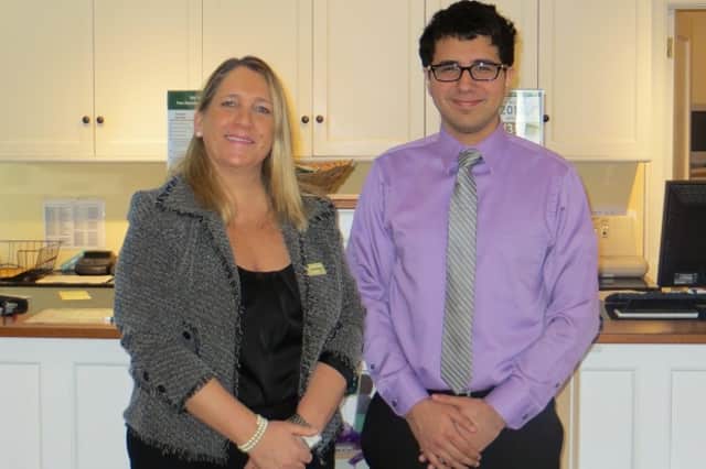 Elizabeth Buzzeo, manager of The Bank of New Canaan's Elm Street branch, with Marcelo Pena