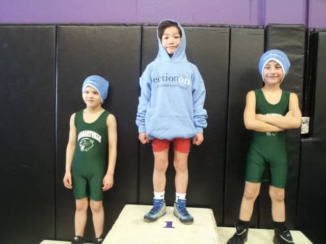 August Hibler, center, won the bantam title at the Section 1 Kids Wrestling Championship/State Qualifier.