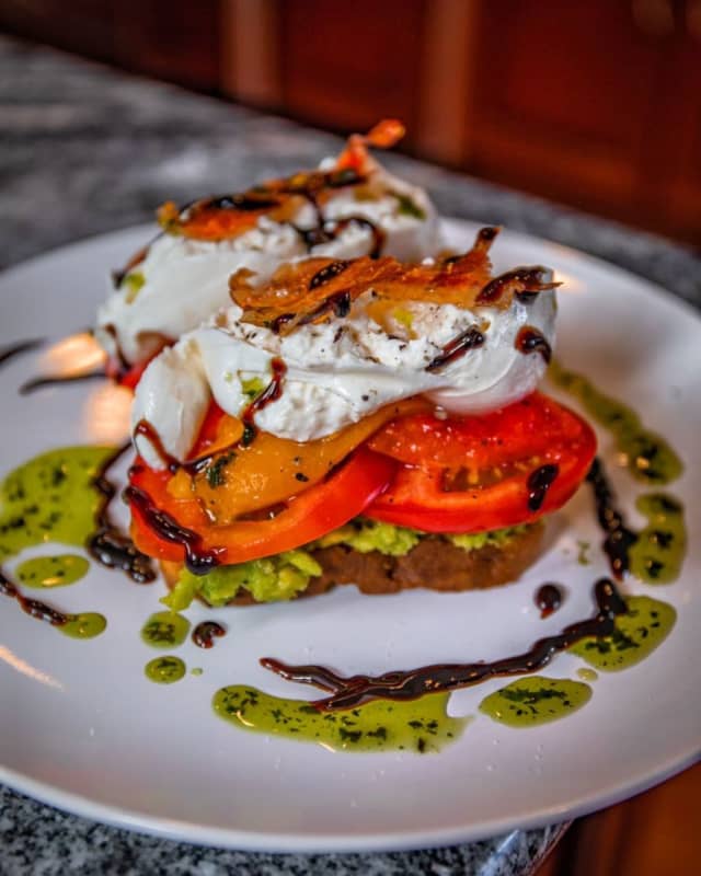 Burrata Avocado Toast with fresh mozzarella, avocado spread, roasted peppers, heirloom tomatoes, candied prosciutto, reduced balsamic and basil oil from ITA Kitchen, newly opened at 45 West Main Street in Bay Shore