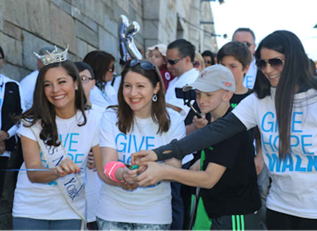 Miss New York Jamie Lynn Macchia, cancer survivors Dana Wershaw and Luke Weber and Soleidy Estevez cut the ribbon at the 22nd Annual Pediatric Cancer Foundation Give Hope Walk April 17.