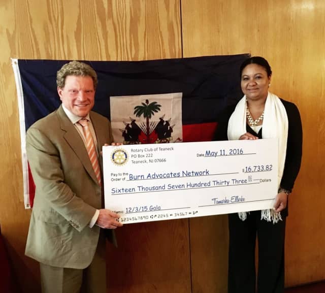 Teaneck Rotary Club President Tamarha Ellerbe presented a check to Samuel Davis to benefit the Burn Advocates Network in Haiti.