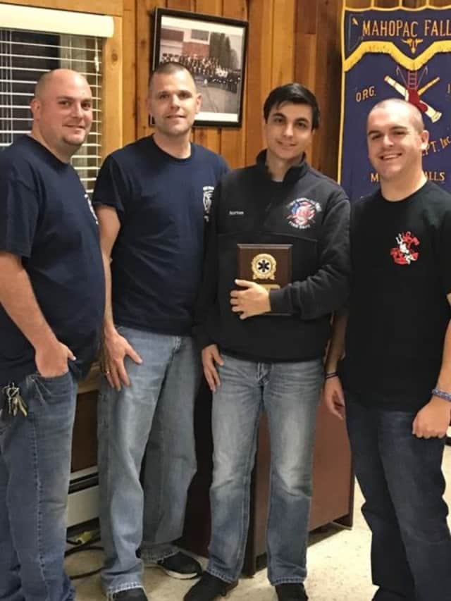 Second Asst. Chief Bob Trace, Chief Jeff Boyle, Firefighter Kevin Norton and First Asst. Chief Brian Sacher during a special ceremony to present Norton with a certificate of merit for saving his grandfather.